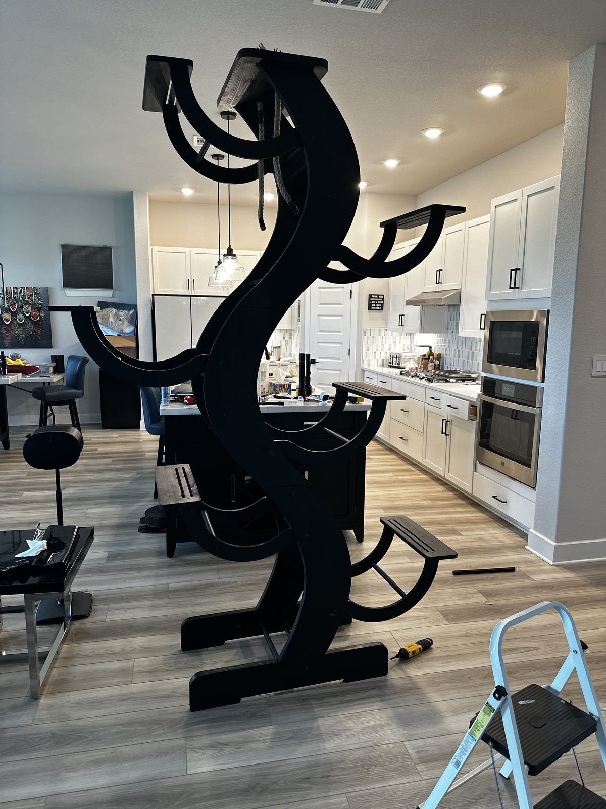 The cat tree assembled and standing in the middle of the floor, before it went up on the wall.