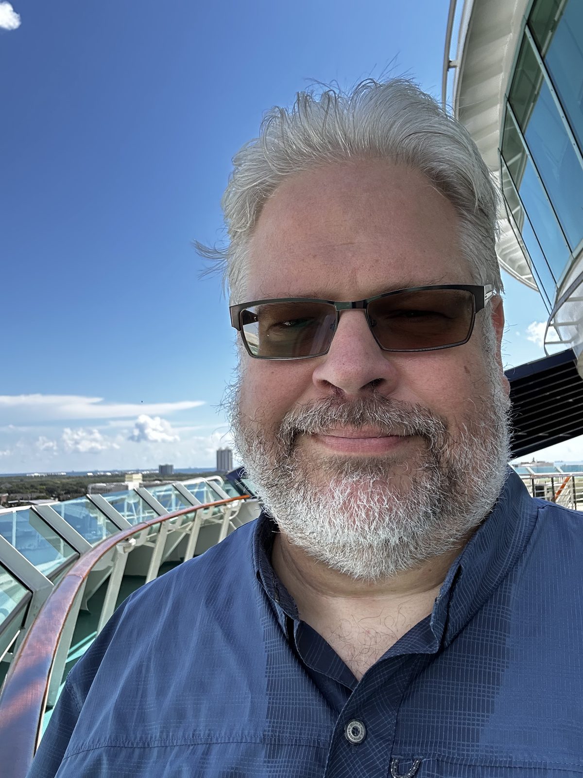 Ernie on deck at Galveston, the ship's glass canopy behind him.