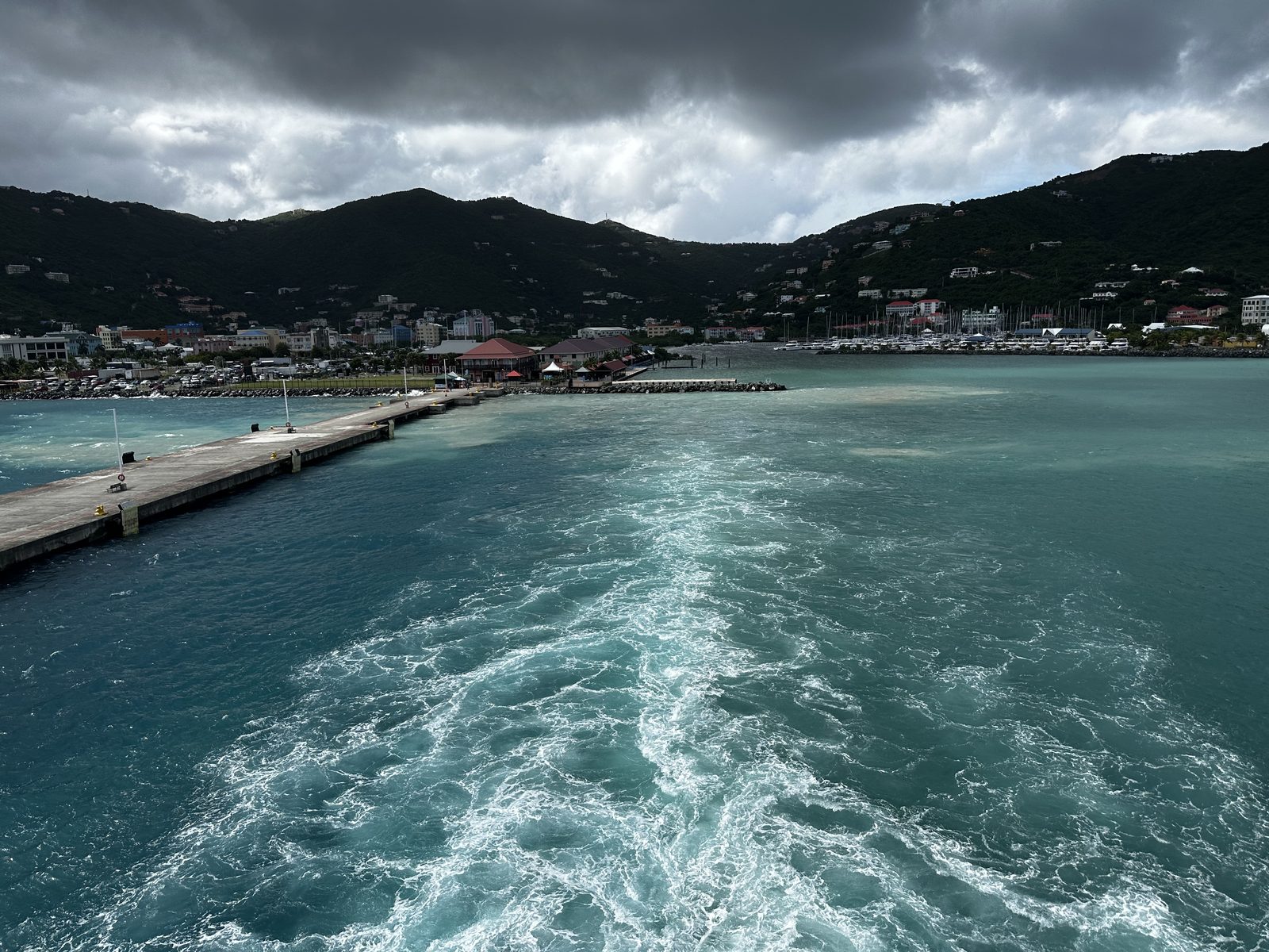 Leaving Road Town, Tortola under a heavy sky, the pier falling astern.